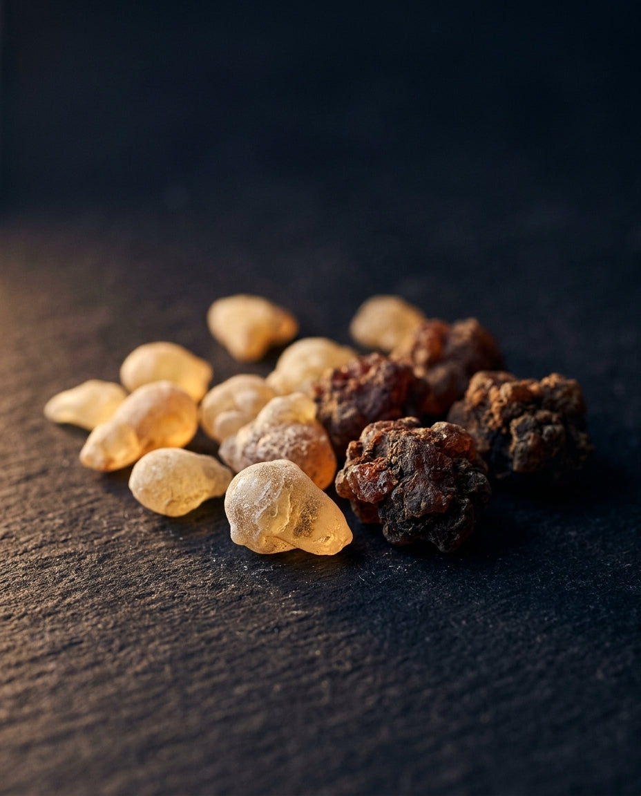 Raw frankincense tears and myrrh resin on dark stone